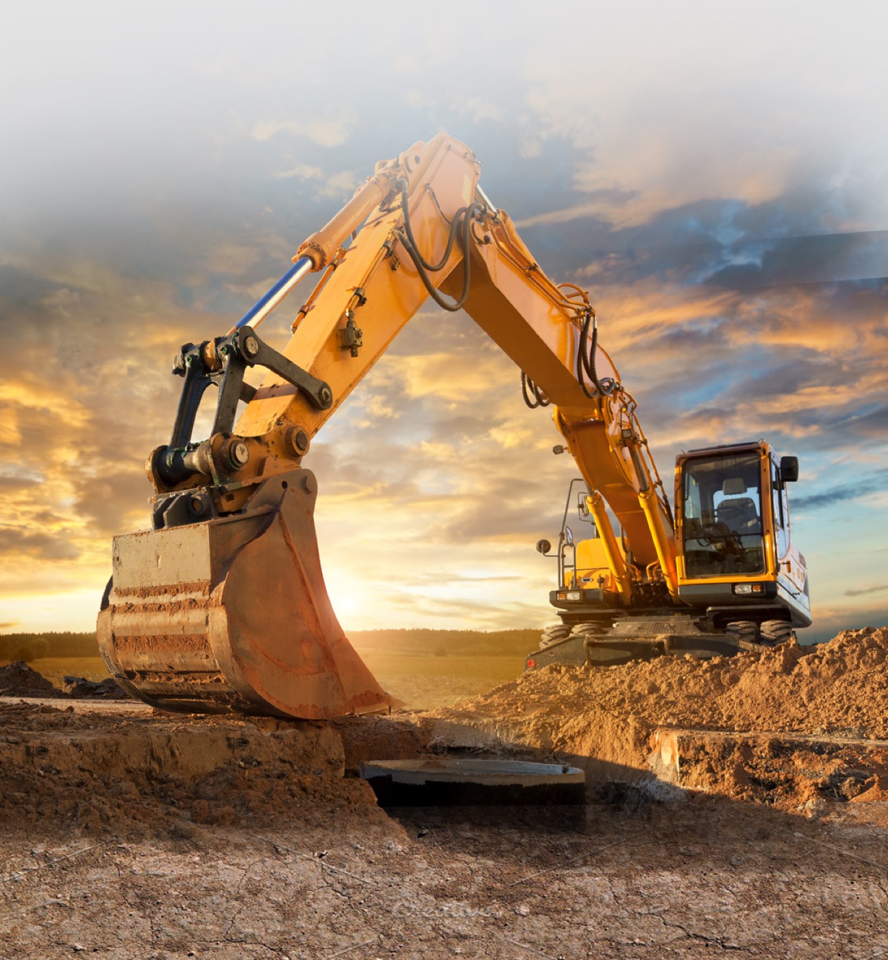 Excavator loading debris on a job site